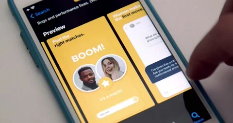 Man watches Bumble app page in App Store by scroll and swipe on iPhone Stock Footage 149427237