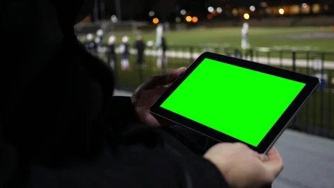Man watches Green Screen Tablet at a Football Team Practice Session from the ble Stock Footage 86001089