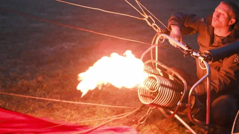 Man watches the process of filling a large balloon with warm air Stock-Footage 155614348