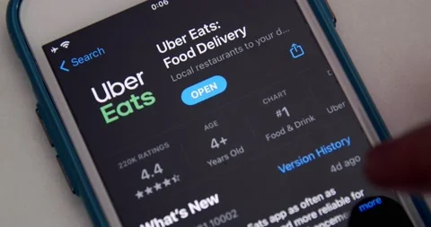 Man watches Uber Eats app introduction page in App Store Stock Footage 149427309