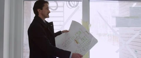Man watching and checking the construction plan of a country house. Stock Footage 149831623