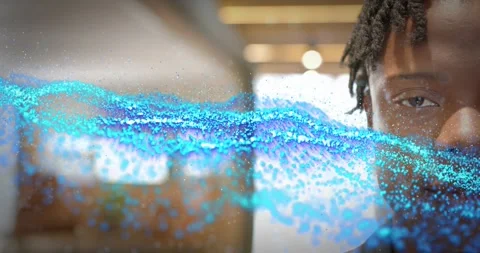 Man watching blue particle stream appearing from left and sweeping across face Видео 318607258
