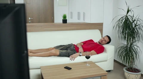 Man watching boring TV programme Stock Footage 47250004