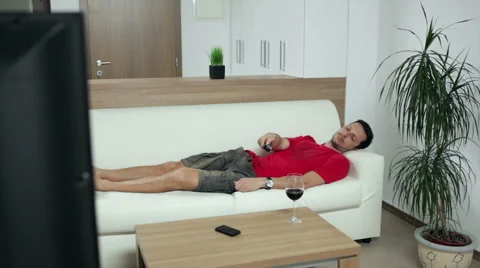 Man watching boring TV programme Stock Footage 47250209