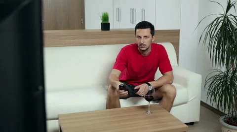 Man watching boring TV programme Video stock 47254436