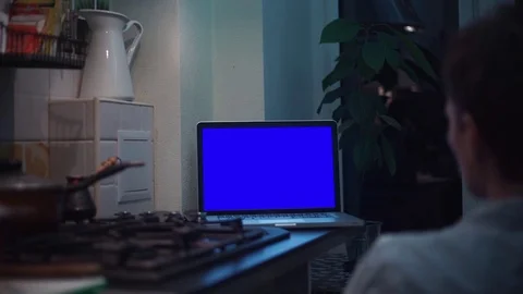 Man watching at chroma key notebook computer screen at kitchen near stove Video stock 83253258