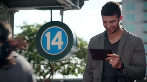 Man watching content on ipad in urban environment Stock Footage 298075173