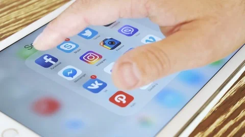 Man is watching Facebook application on white iPad. Stock Footage 76999153