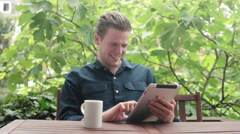 Man watching funny video while a having a coffee Stock Footage 40674611