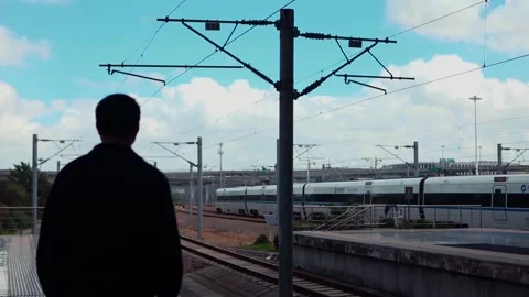 Man watching the high-speed train exiting the station Stock Footage 234495463