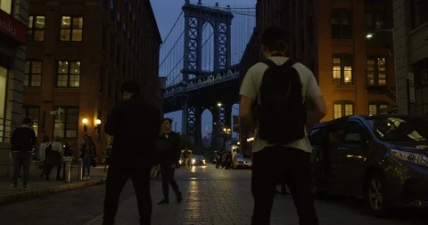 Man Watching The Infamous Manhattan Bridge At Night In the Busy Streets Stock Footage 110597744