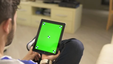 Man watching on an iPad Stock Footage 87385062