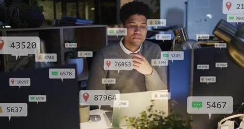 Man watching laptop, getting alerts and processing tech data while badges Stock Footage 330192071