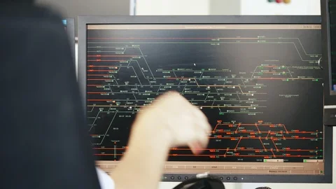 Man watching movement of trains on computer monitor Stock Footage 95617578