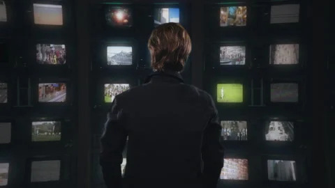 Man Watching Multiscreen Television Monitors Spinning Around Stock Footage 161885046
