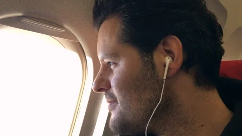 Man watching out of a airplane window Video stock 112080186
