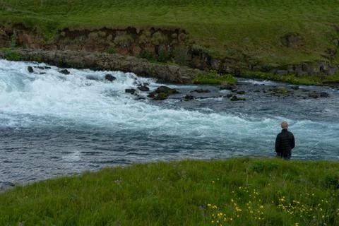 Man watching the river flow 库存照片