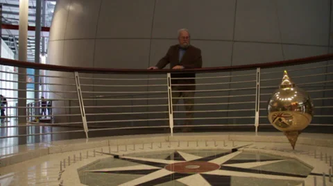 Man watching the rotatig pendulum Stock Footage 36150666