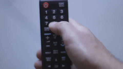 Man Watching Smart TV And Using Modern Black Remote Controller. Top view Stock Footage 153997685