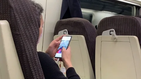 Man Watching Smartphone In A Train Stock Footage 107939985