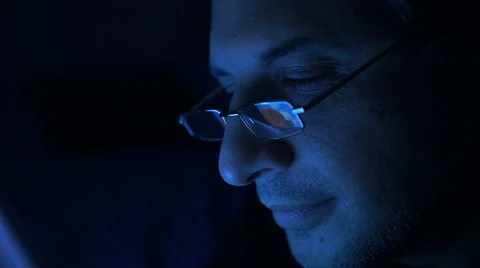 Man watching something on computer at night Stock Footage 59859244