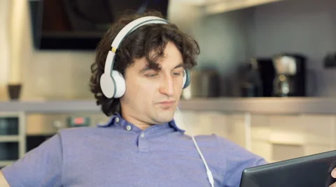 Man watching something on tablet and woman using smartphone, steadycam shot Video stock 62887122