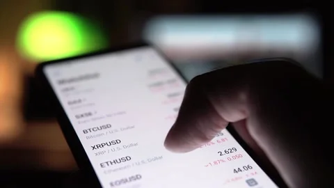 Man is watching stock charts and prices on smartphone Stock Footage