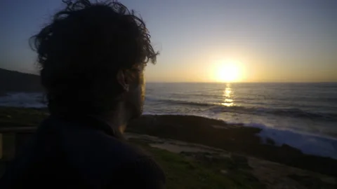 Man watching the sunset and thinking to big cliffs in Basque Coast, Spain Video stock 154777220