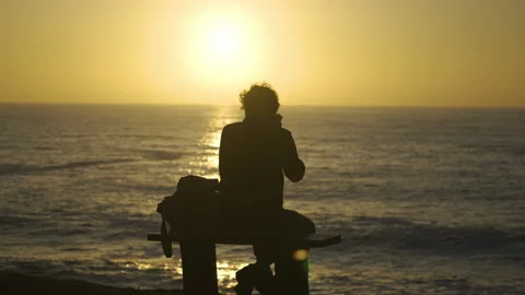 Man watching the sunset around big cliffs in Basque Coast, Spain Video stock 154777011