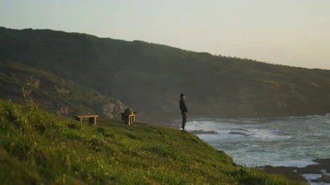 Man watching the sunset around big cliffs in Basque Coast, Spain Video stock 154777104