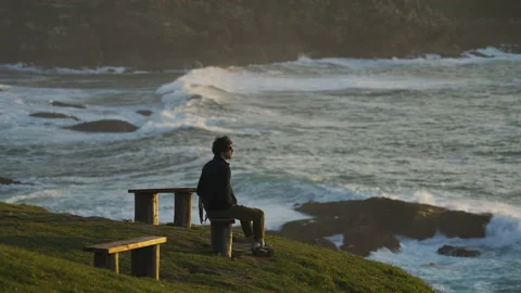 Man watching the sunset around big cliffs in Basque Coast, Spain Video stock 154777168