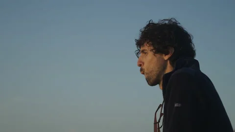 Man watching the sunset around big cliffs in Basque Coast, Spain Video stock 154777260