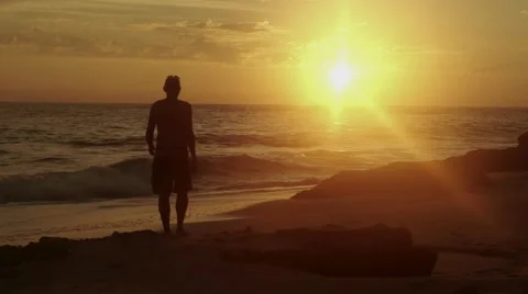 Man watching sunset on the beach Stock Footage 46083126