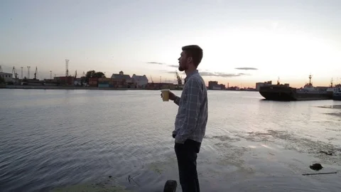 Man watching sunset drink coffee on sea port hd Stock Footage 70772392