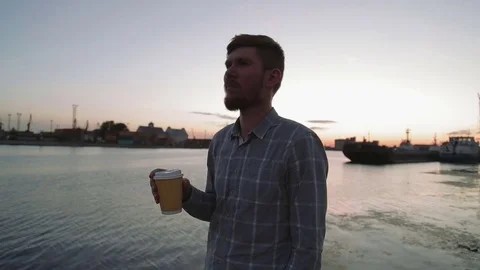 Man watching sunset drink coffee on sea port hd Stock Footage 70772591
