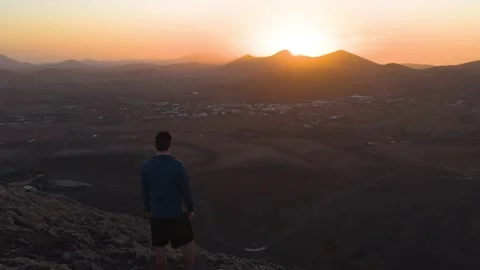 Man watching sunset over volcanic landscape scenic wide view 스톡 동영상 331193723