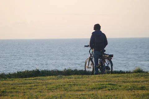 Man watching the sunset Stock Photos