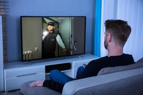 Man Watching Suspense Movie On Television Stock Photos