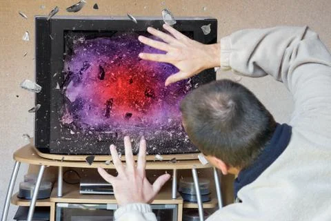 Man watching television that explodes Stock Photos