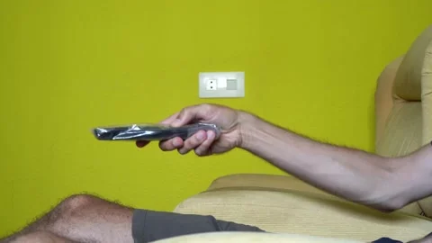 Man watching television whose remote control does not work. Stock Footage 159969397