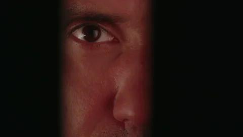 Man watching through a crack 動画素材 236089378