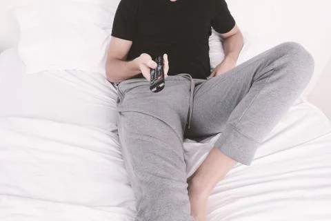Man watching tv on bed. Stock-Fotos