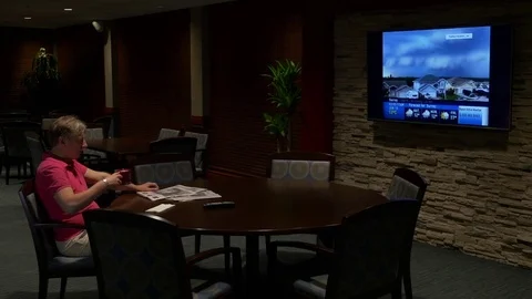 A man watching TV, drinking coffee in a club(side view) 스톡 동영상 77174945