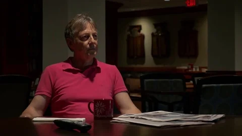 A man watching TV, drinking coffee in a club (medium shot) Видео 77174991