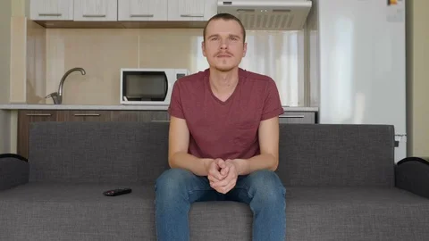 A man is watching TV Stock Footage 107653390