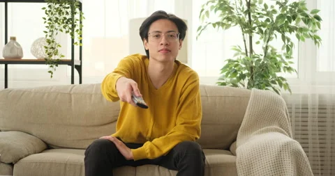 Man watching tv sitting on sofa Video stock 145293429