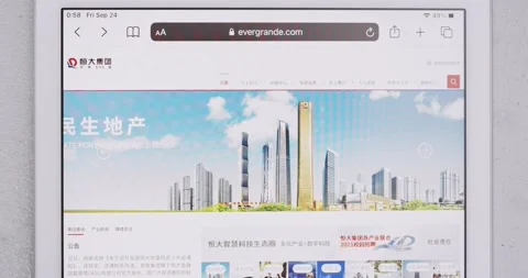 Man watching website of The Evergrande Group on iPad Stock Footage 161463504