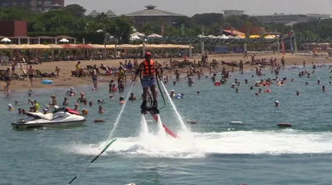 Man on Water Jet Pack Flyboard near Sea Beach Resorta ans people Crowd Stock Footage 40324545