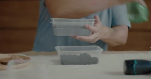 Man water peat inside a clear container Stock Footage 240385955