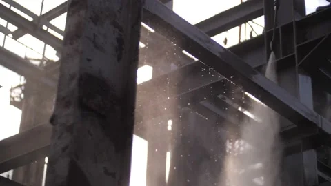 A man with a water pressure compressor washes scaffolding at a height. Stock-Footage 229556235